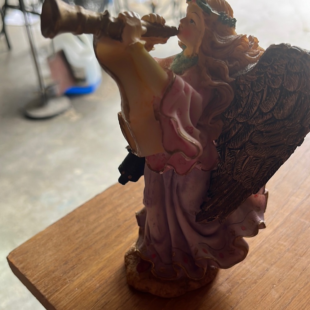 Antique Angel playing trumpet